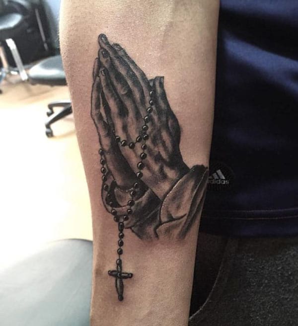 Praying Hand Tattoo on their lower arm makes a man look cool