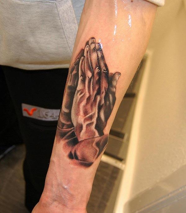 Praying Hand Tattoo on the lower arm makes a man look cool