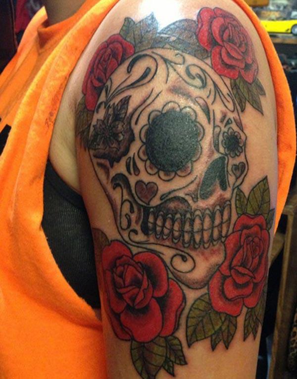 The Sugar skull tattoo with 4 roses on female arm