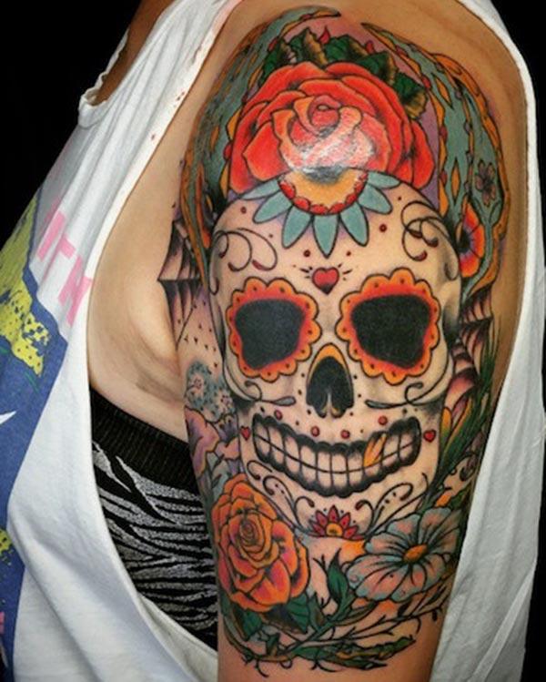 The multicolor sugar skull tattoo on female arm