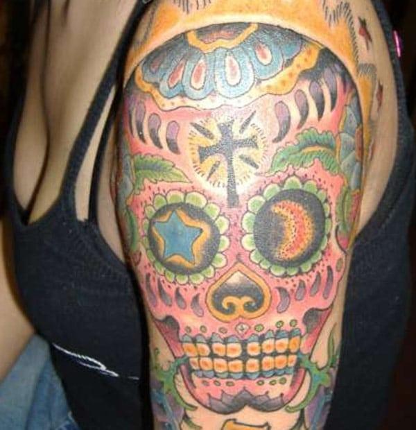 The sugar skull tattoo on girl’s arm
