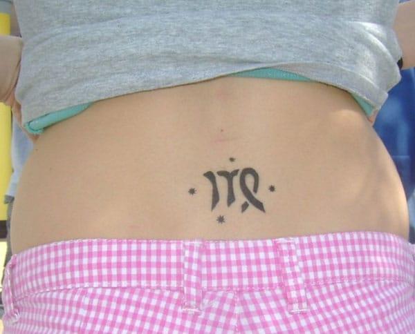 Virgo tattoo on above the hips with a black ink design brings the captivating look