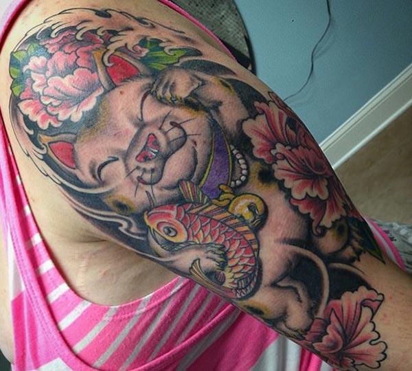 Awesome Tattoo on the shoulder with a pink ink design flower brings a feminist look