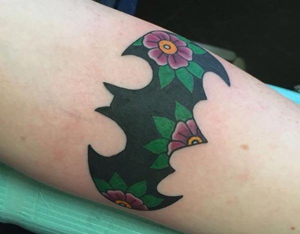 Bat tattoo on the arm with flower design brings the elegant look