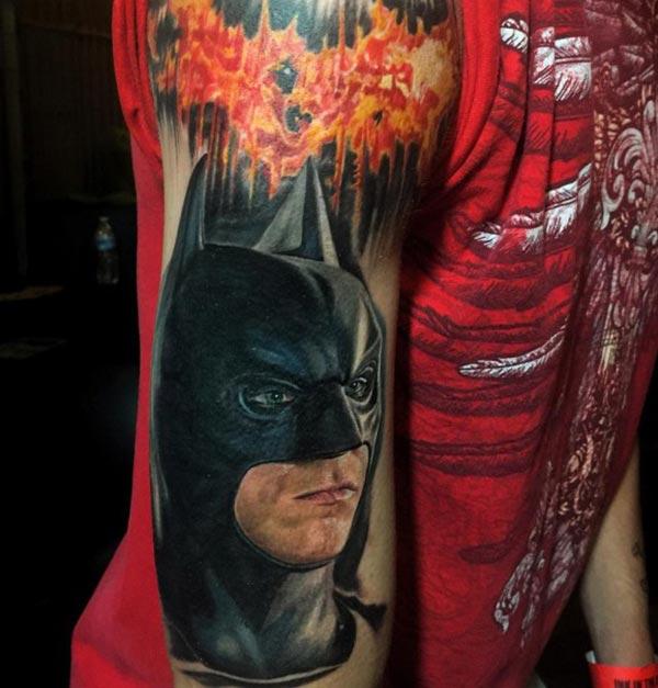 Batman tattoo with a black ink design on the upper arm shows their foxy look