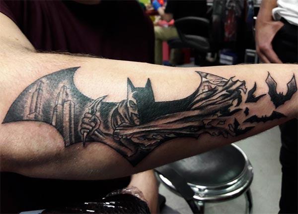 Batman tattoo on lower arm make a man look cool