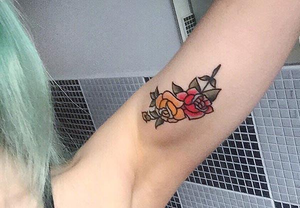 Bicep tattoowith a flower ink design makes a girl alluring