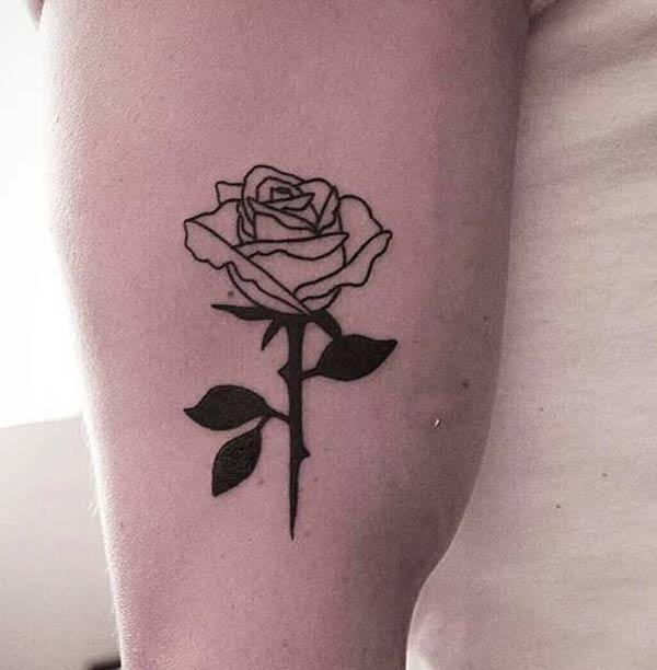 Bicep Tattoo for men with a black design ink flower make them look attractive