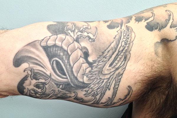 Bicep Tattoo for men with ink design brings their elegant