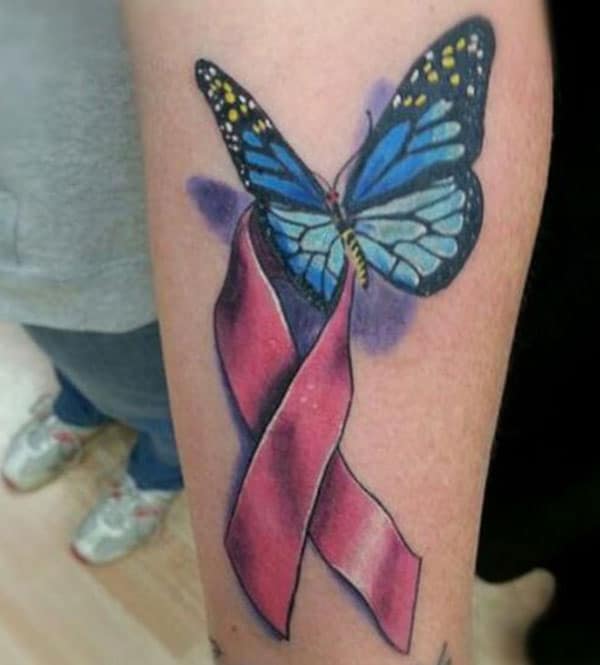 Cancer Ribbon tattoo on the lower arm gives the doleful look