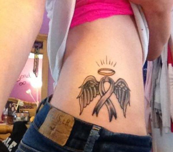 Cancer Ribbon tattoo on the side belly shows the dispirited look