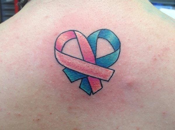 Cancer Ribbon tattoo on the back gives the somber moment