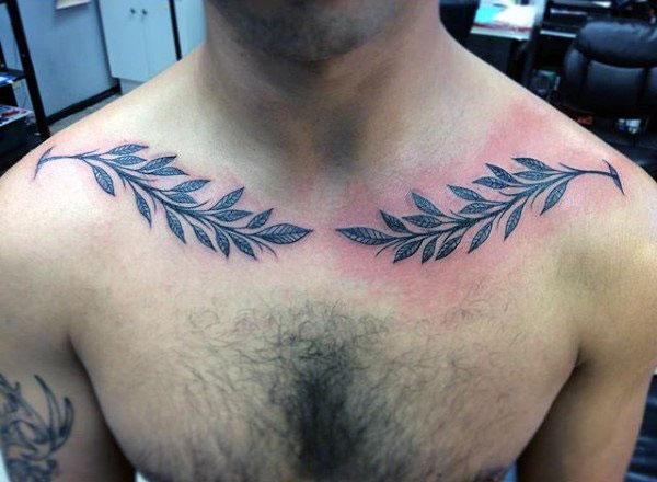 Collar Bone Tattoo with black flower ink design makes a man have a hunky look