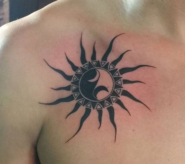 Collar Bone Tattoo with a black circular drawing make a man have an august look