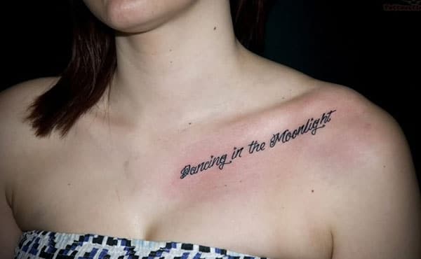 Collar Bone Tattoo with a black ink message brings a feminist look