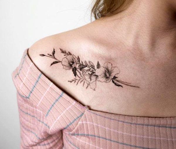 Collar Bone Tattoo with a flower design matches the skin color to make a woman look magnificent