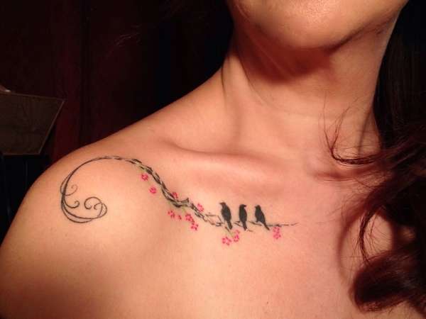 Collar Bone Tattoo with a pink flower and black birds makes a girl alluring