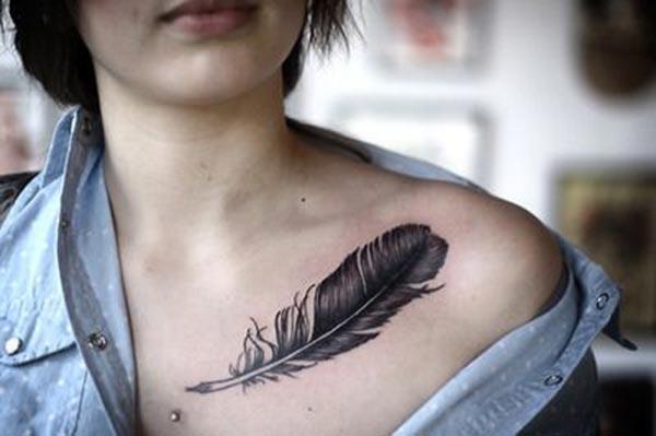 Collar Bone Tattoo with a brown feather brings a feminist look