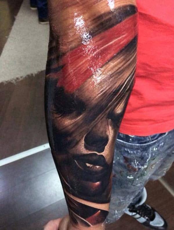 Black and pink ink face design on the Forearm Tattoo for men make them look elegant