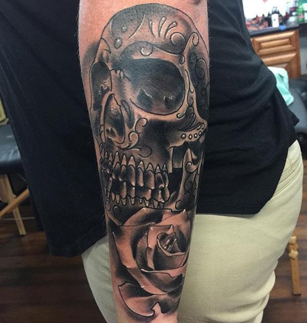 Forearm Tattoo with a black ink design skull brings the flashy appearance in girls