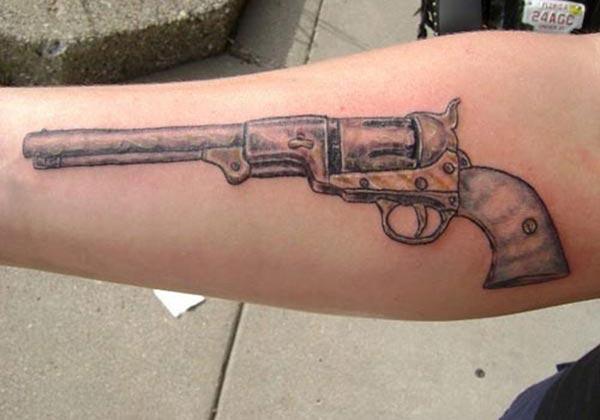 Gun Tattoo on the lower arm makes a man look cool