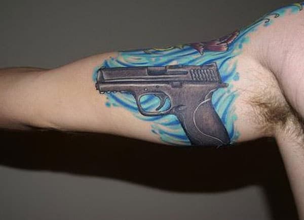 Gun Tattoowith a gray ink design make a man look stylish