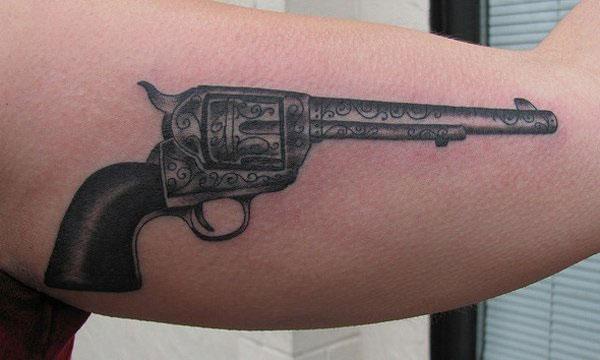 Gun Tattoo for men with a black ink design brings their elegant
