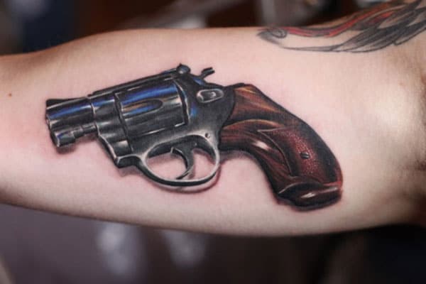 Gun Tattoo for men with the brown design makes them look attractive