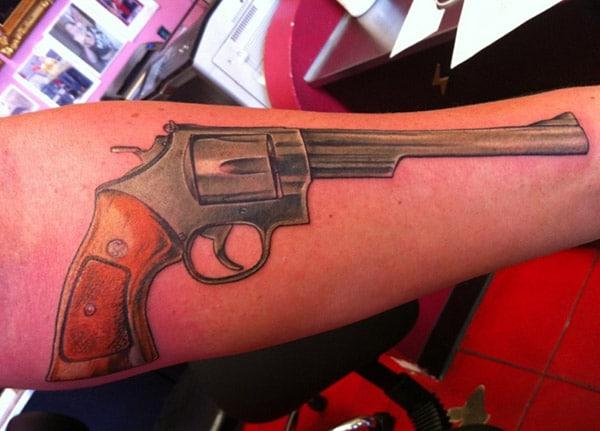Gun Tattoo on the arm makes a man look gallant