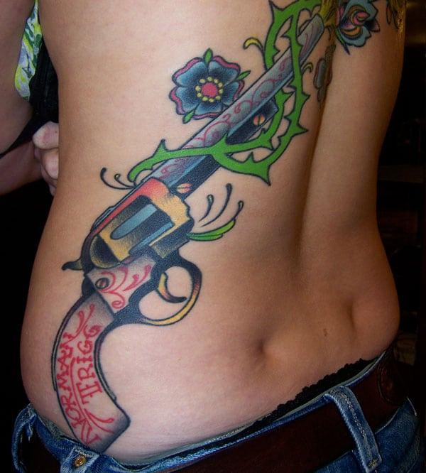 Gun Tattoo at the back makes a man appear stylish