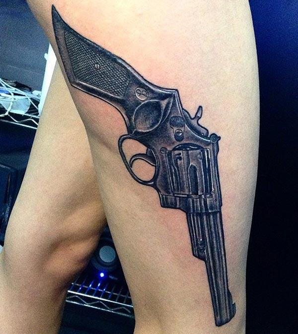 Gun Tattoo on the thigh makes a man look lovely