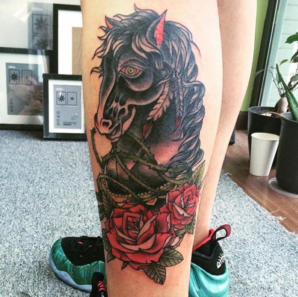 Horse tattoo on the legs makes ladies look lovely.