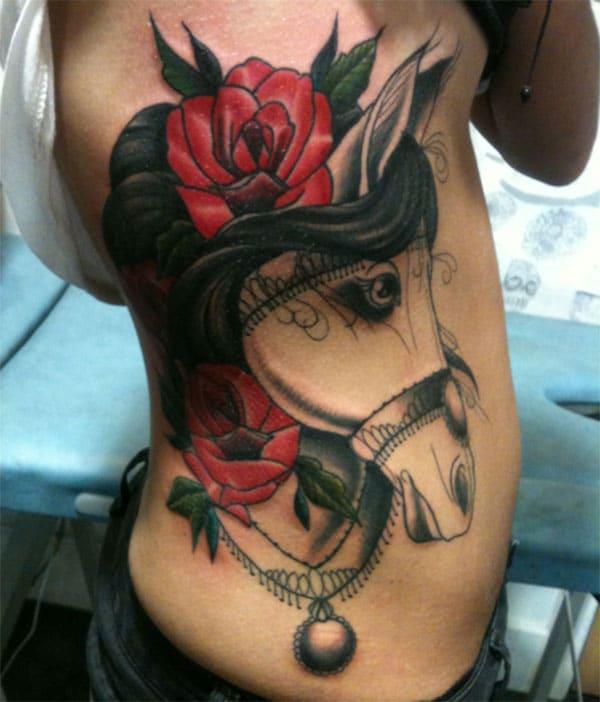 Horse tattoo on the side with a pink flower ink design brings a gorgeous look