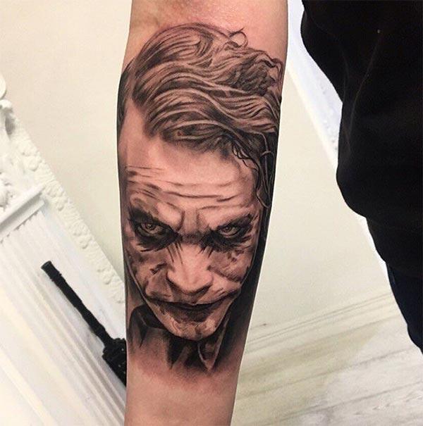 Joker Tattoo with a blue ink design on the lower arm shows their foxy look