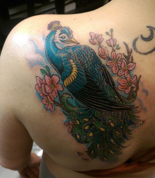 Peacock Tattoo on the back shoulder makes a man look attractive