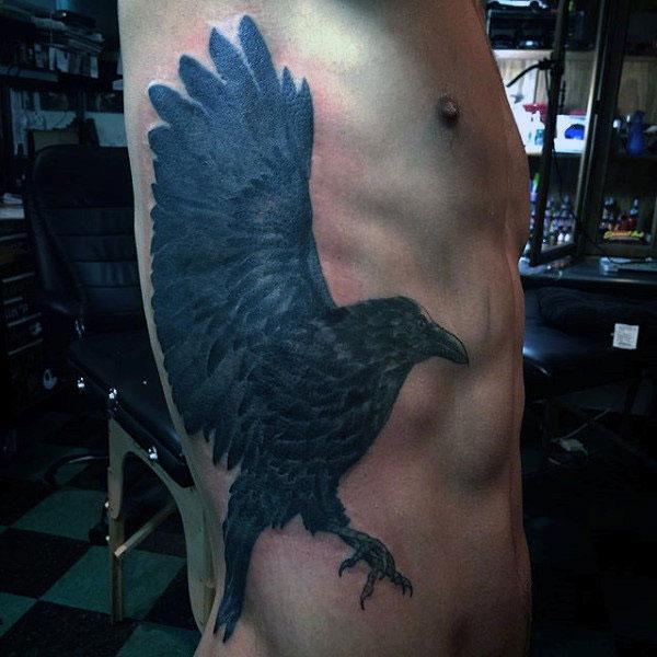 Raven tattoo on the side belly make a man look cool