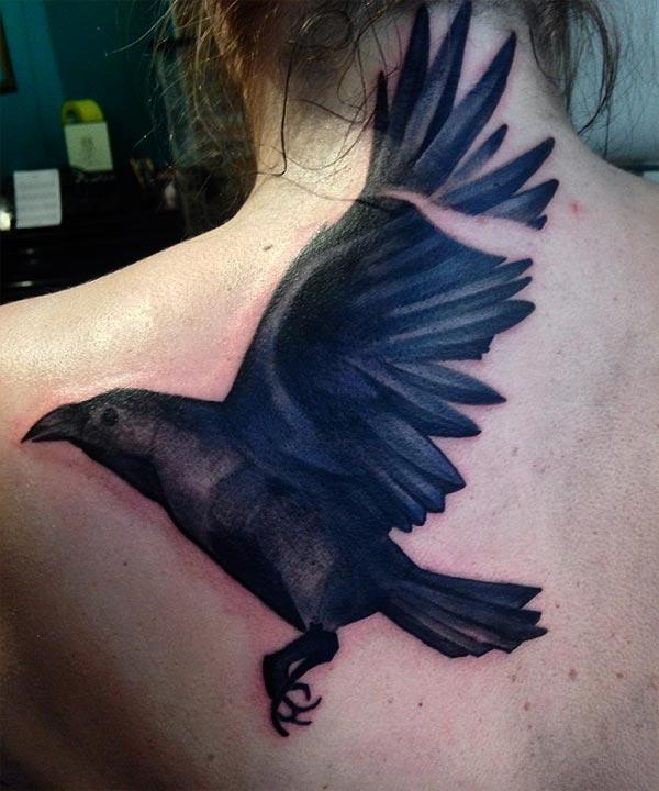 Raven tattoo on the back makes a girl look so cute