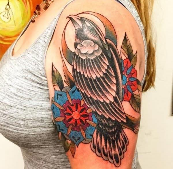Raven tattoo on the shoulder brings the captivating look