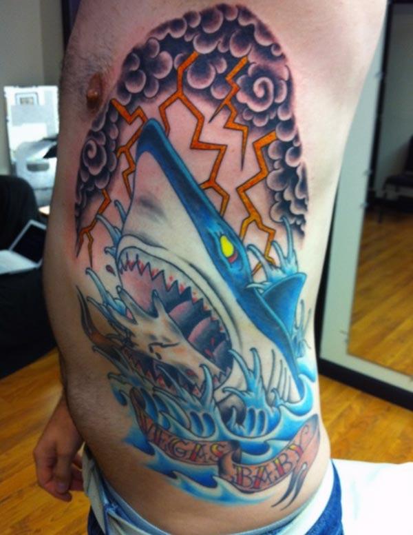 Shark Tattoo on the side with a blue ink design make a man look cool