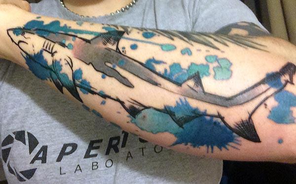 Shark Tattoo for men with the black ink design and blue background make them look magnificent