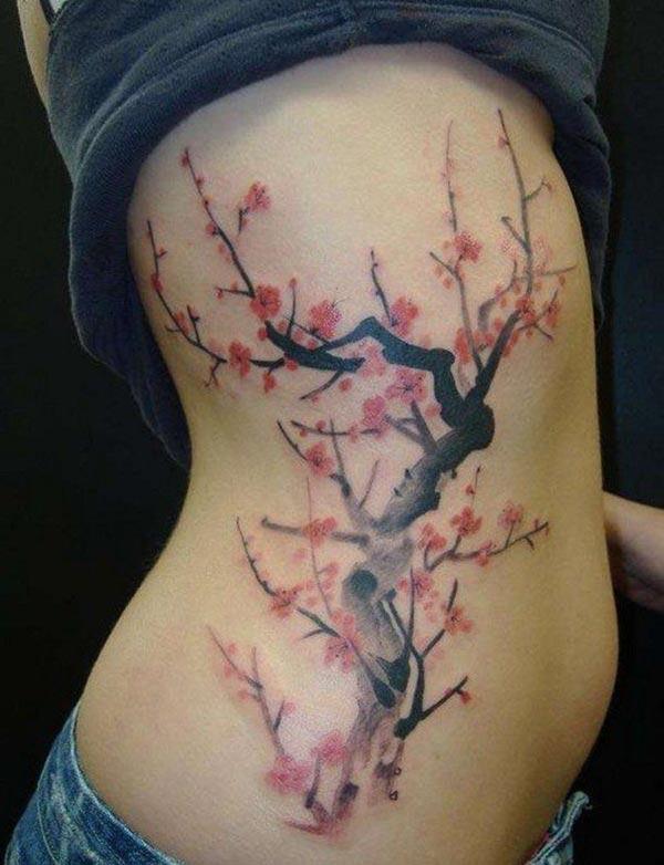 Side tattoo for Women with a pink flower give them the pretty and attractive appearance