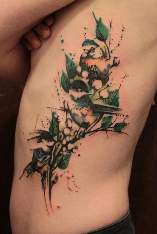 Side tattoo for men with a green flower ink design makes them eye-catching