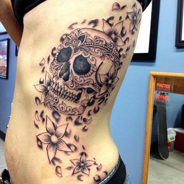 Side tattoo for men with a black skull ink design make them look cool