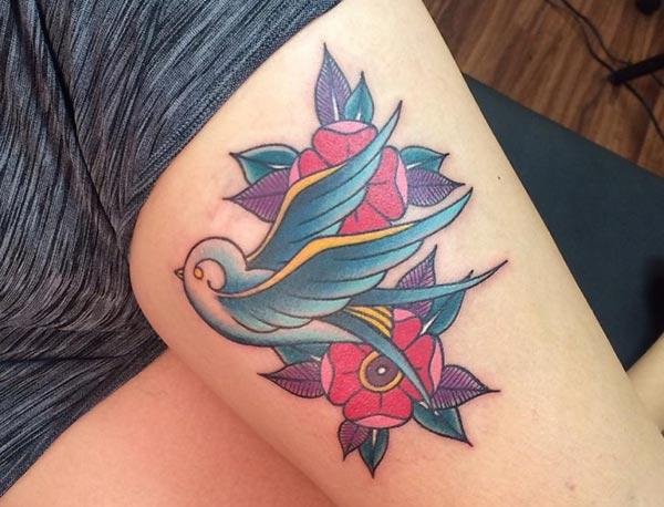 Sparrow tattoo for the upper thigh brings their feminist look.
