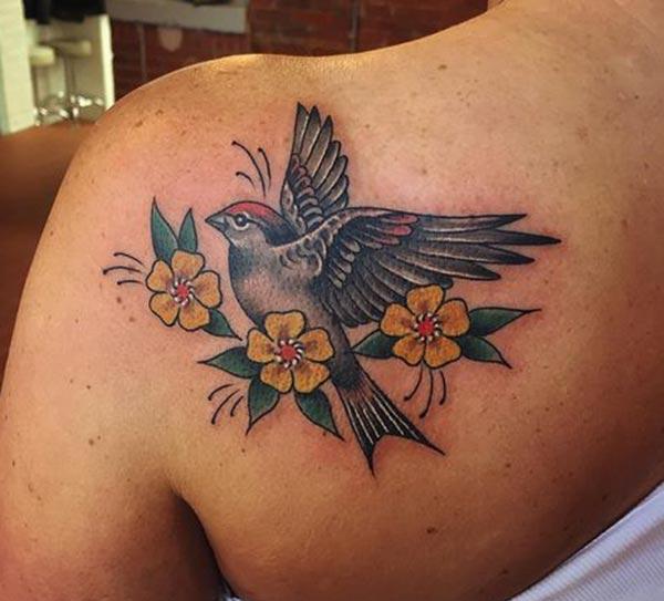 Sparrow Tattoo for Women with a yellow flower give them the pretty and attractive appearance