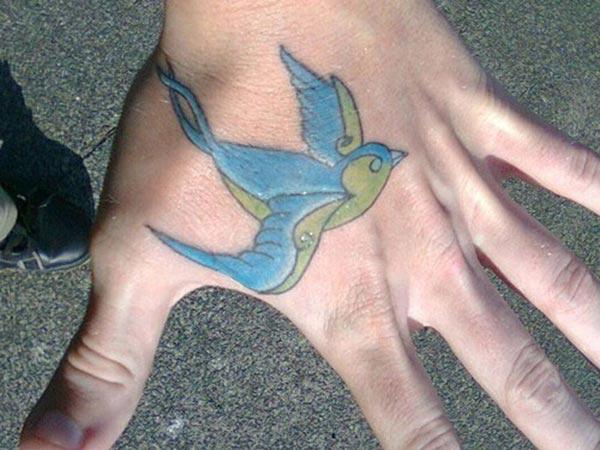 Sparrow tattoo on the hand makes a man look stylish