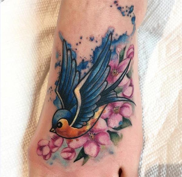Sparrow tattoo on foot makes a girl look attractive