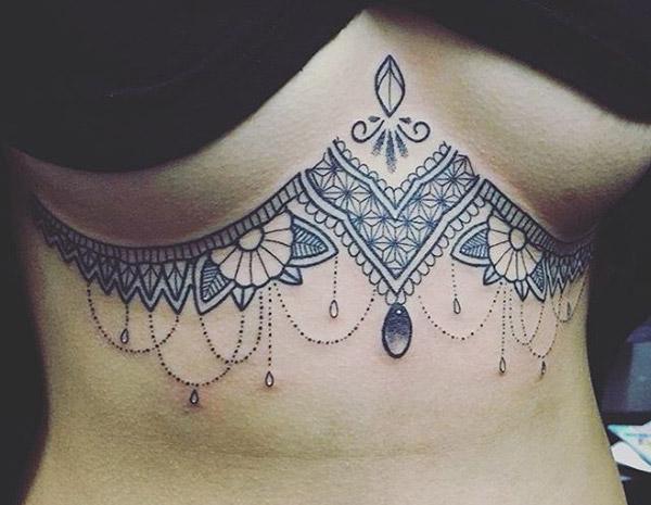 Sternum tattoo with a black ink design brings a feminist look