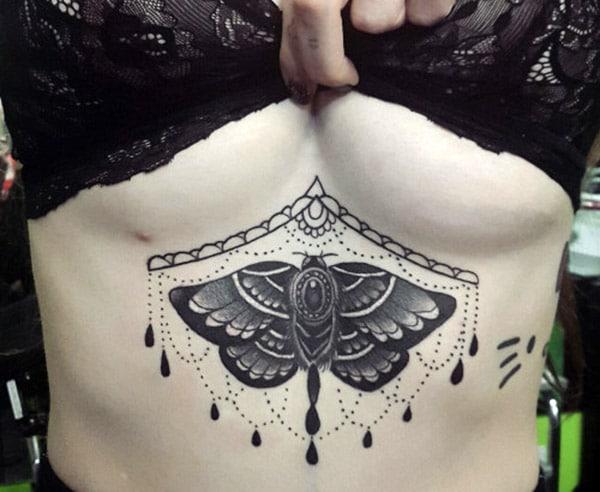 Sternum tattoo for Women with blue and brown ink design makes them look attractive