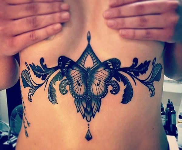 Sternum tattoo for Women with black ink design make them look attractive